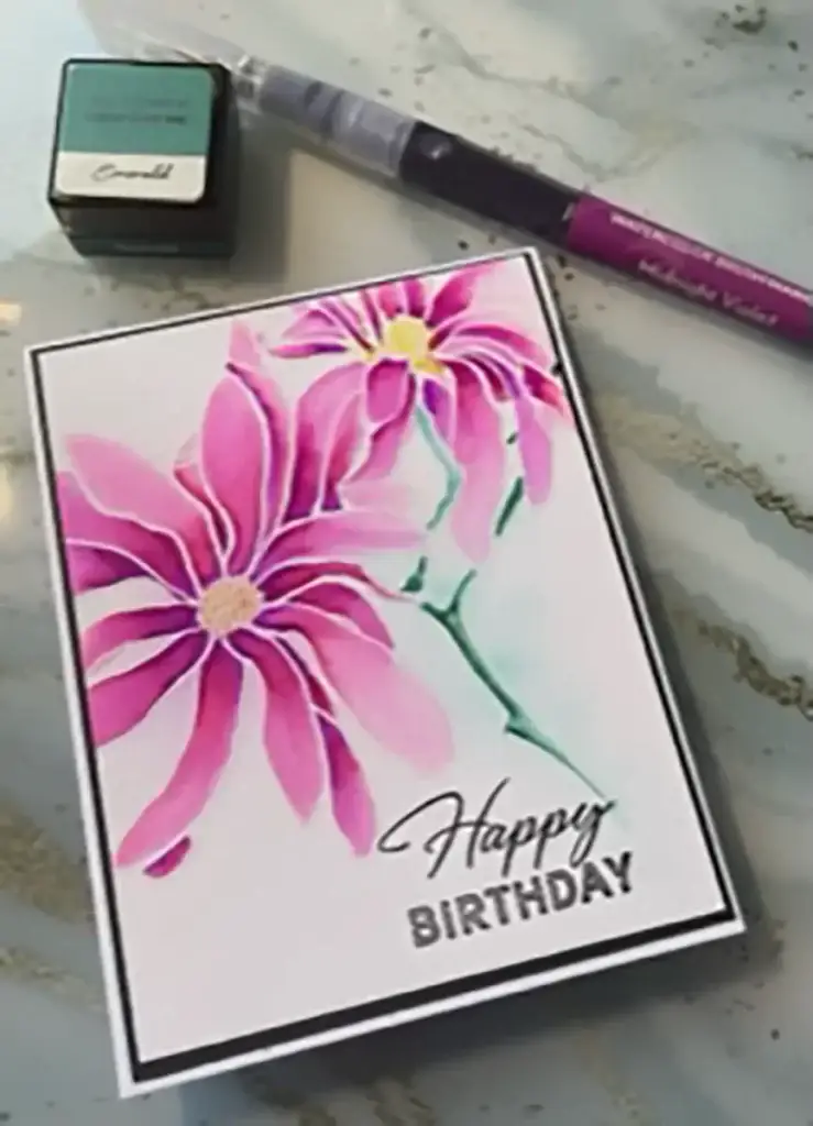 A birthday card with pink flowers created using 4 ways to watercolor.