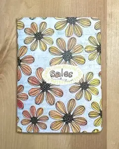 A Crafters Traveler's Notebook with a flower design on it.