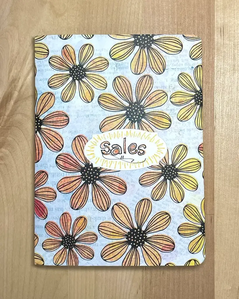 A Crafters Traveler's Notebook with a flower design on it.
