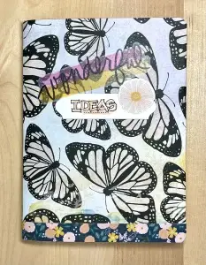 Crafters Traveler's Notebook adorned with butterflies and flowers.