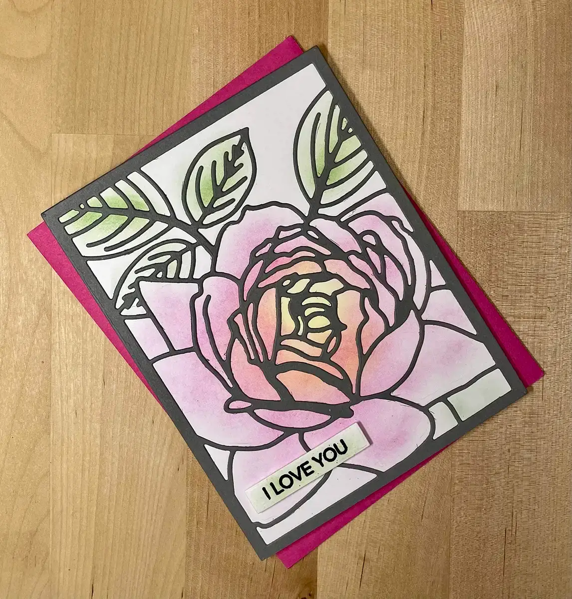A card with a fantastic pink rose on it.