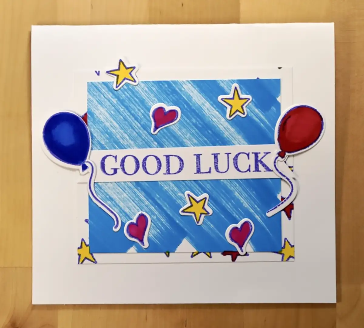 A pop-up card featuring balloons and stars, bringing good luck.