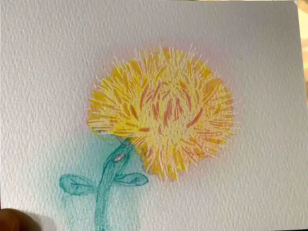 A drawing of a yellow dandelion on a piece of paper using watercolor techniques.