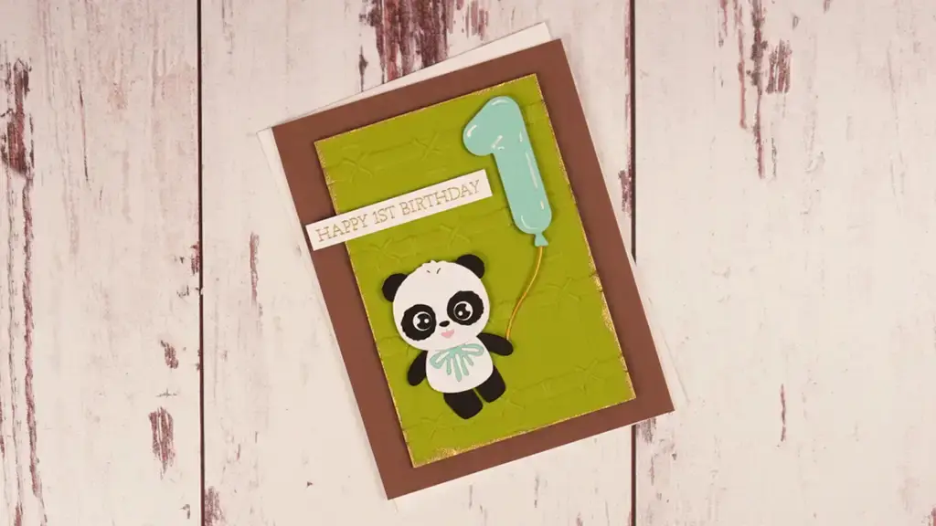A birthday card featuring a panda holding a balloon.