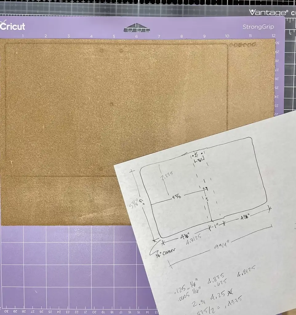 A Crafters Traveler's Notebook resting on a piece of paper, accompanied by a pencil and ruler.