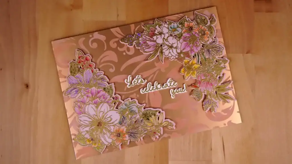A Mother's Day card with flowers on it on a wooden table.