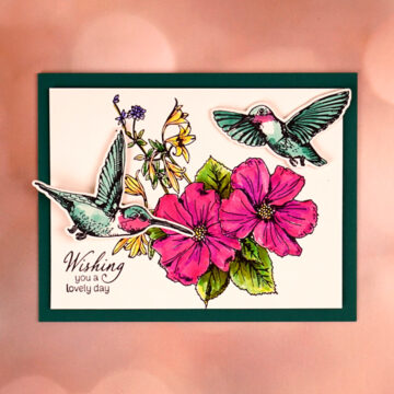 A handmade card with hummingbirds and flowers made with Spellbinders' new "Flutter Into Spring" BetterPress plate of the month.