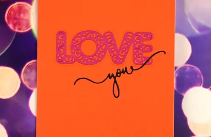An orange card with the words love you on it.