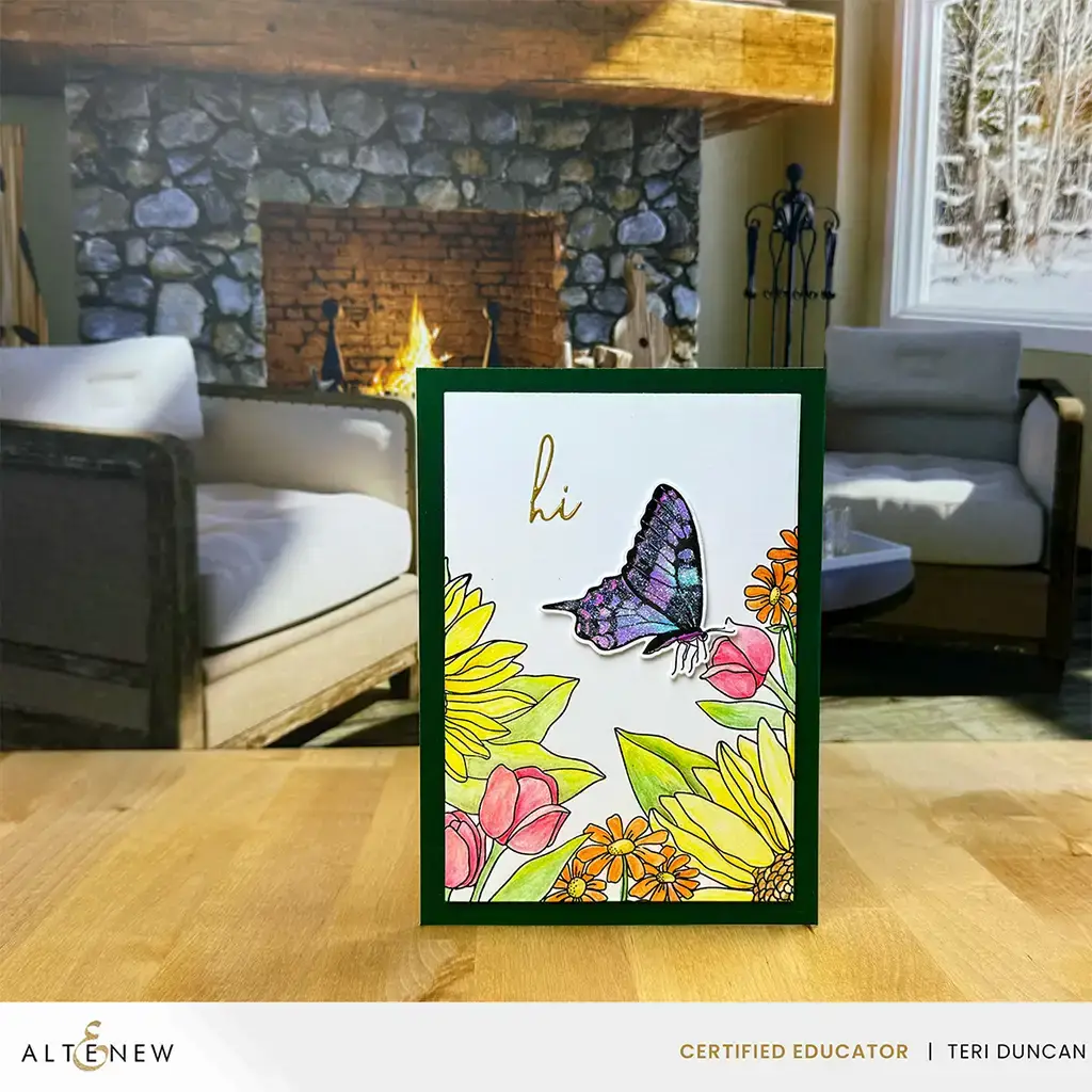 A card with wild wonders - a butterfly and flowers - in front of a fireplace.