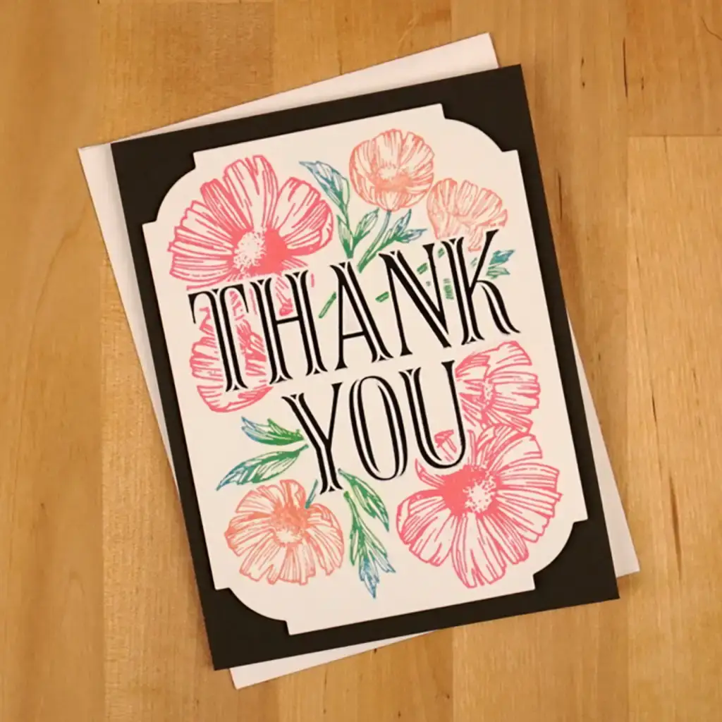 A thank you card with pink flowers on it. A greeting card created using the versatility of the new Registration Place & Press collection with flowers on it.