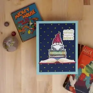A card with a gnome and a book next to it made with Spellbinders March 2024 Monthly Club kits.