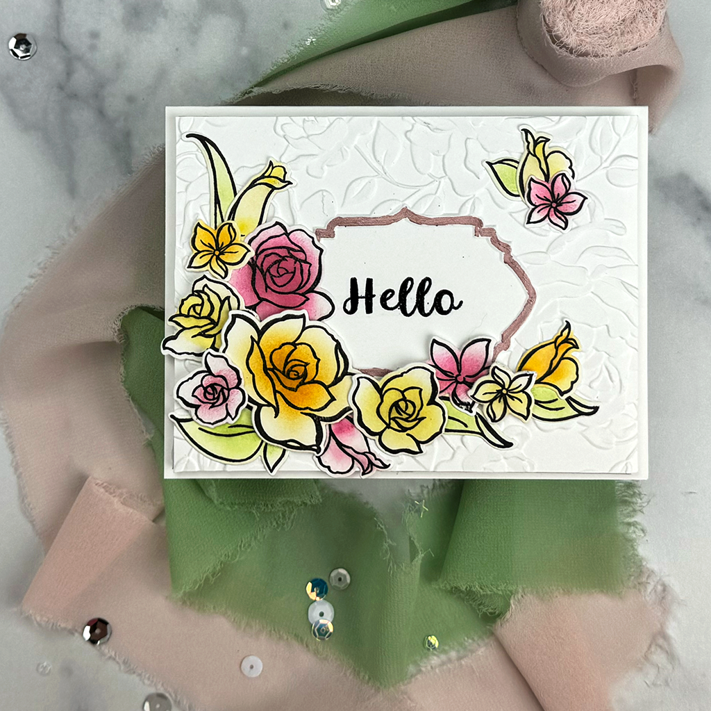 You can ink-blend floral stamps to create a beautiful "Rosey Hello" card like this. It's got multi-color flowers that accent a pretty framed Hello sentiment.