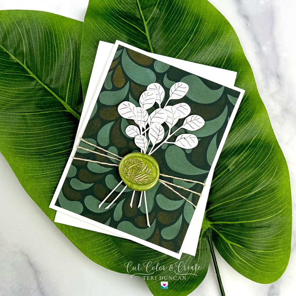 WSOM May24 B is used to create the Tropical hi card. Lovely white sprigs atop a deep green background and sealed with a tropical wax seal.