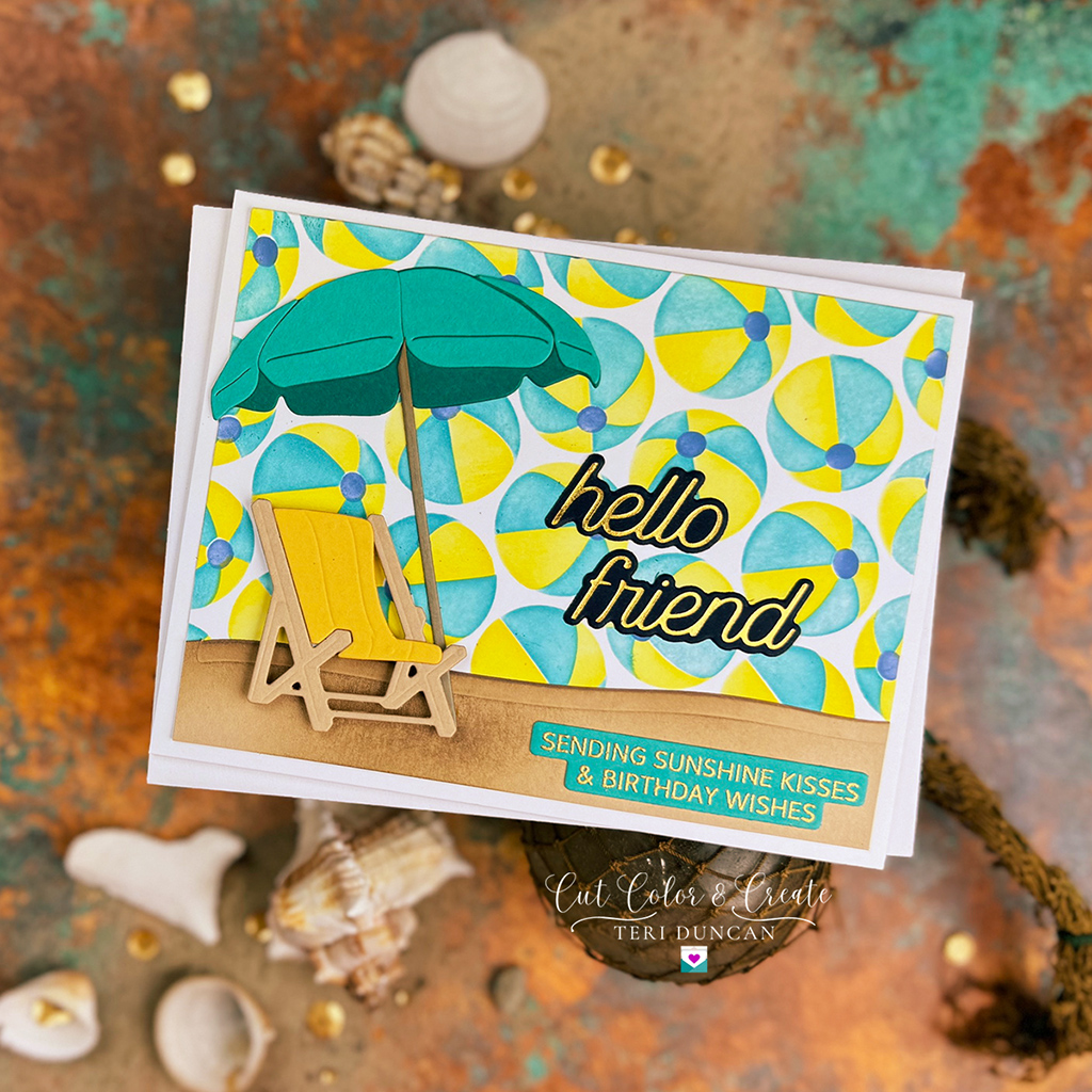 Handmade beach card with a pretty beach ball background created using Spellbinder's Stencil of the Month.