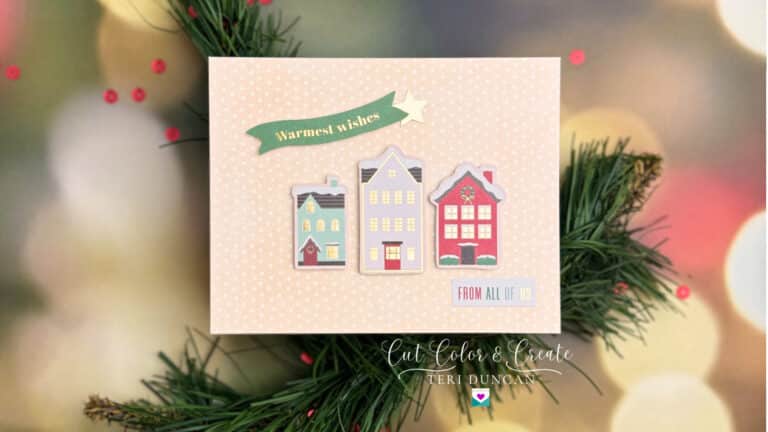 Handmade Christmas card decorated with three little houses. Spellbinders Handmade Holidays cardmaking kit.
