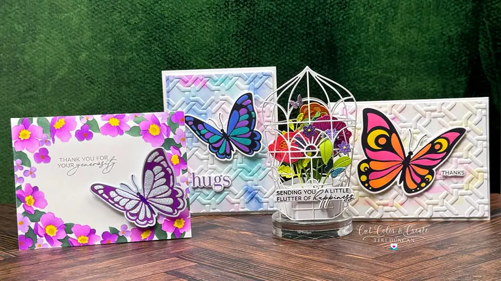 Four vibrant butterfly-themed greeting cards, reflecting the lively essence of spring, with colorful designs and thoughtful messages displayed on a wooden surface. Spellbinders January '25 Club kits are used to create these cards.