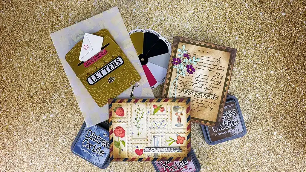 Discover our exclusive April 25 Club Kits, featuring a collection of handmade cards and envelopes on a glittery background, accompanied by vibrant ink pads and a color wheel for endless creativity.