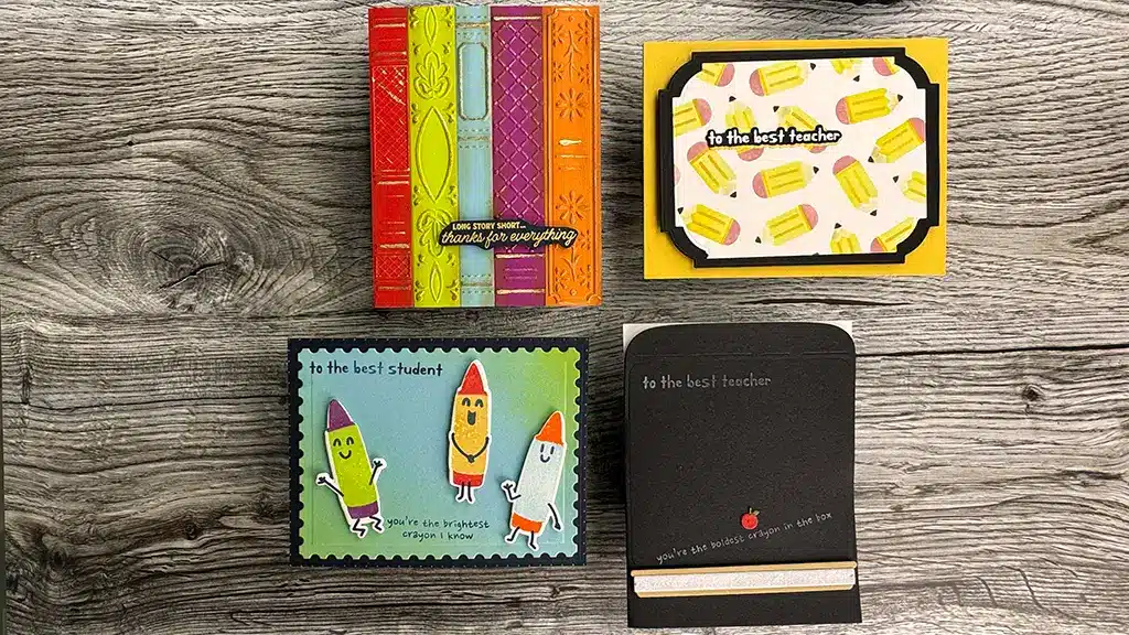Four handmade teacher appreciation cards sit on a wooden surface, each featuring colorful school-themed designs and thank you messages—perfect inspiration for your next card making project or to use with May '25 Club Kits.