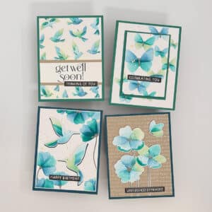 Set of 4 handmade cards with teal and blue floral and bird designs, each featuring a unique message: get well soon, celebrating you, happy birthday, and with deepest sympathy.
