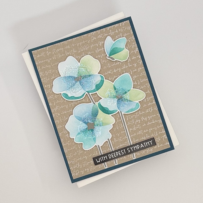 A Flit & Flitter sympathy card with blue and green watercolor flowers on a tan background with cursive writing, featuring the message "With Deepest Sympathy." Thoughtfully designed, this handmade card comes in a set of 4.
