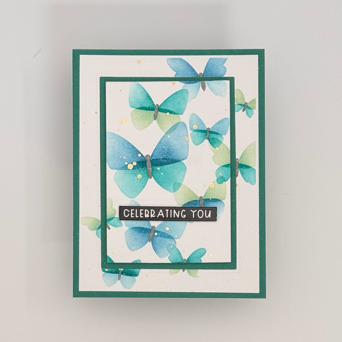 Set of 4 handmade cards featuring green and blue watercolor butterflies from the Flit & Flitter collection, with "CELEBRATING YOU" in white text on a black background.