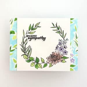 A Floral Sympathy card featuring a floral wreath and the text "With deepest sympathy" on a white background with green and blue accents.