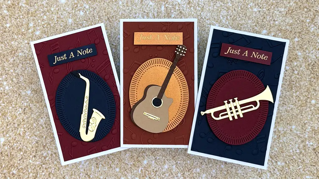 Three music-themed greeting cards featuring a saxophone, guitar, and trumpet—each with "Just A Note" on a colored, textured background—make perfect musical greeting cards for any occasion.