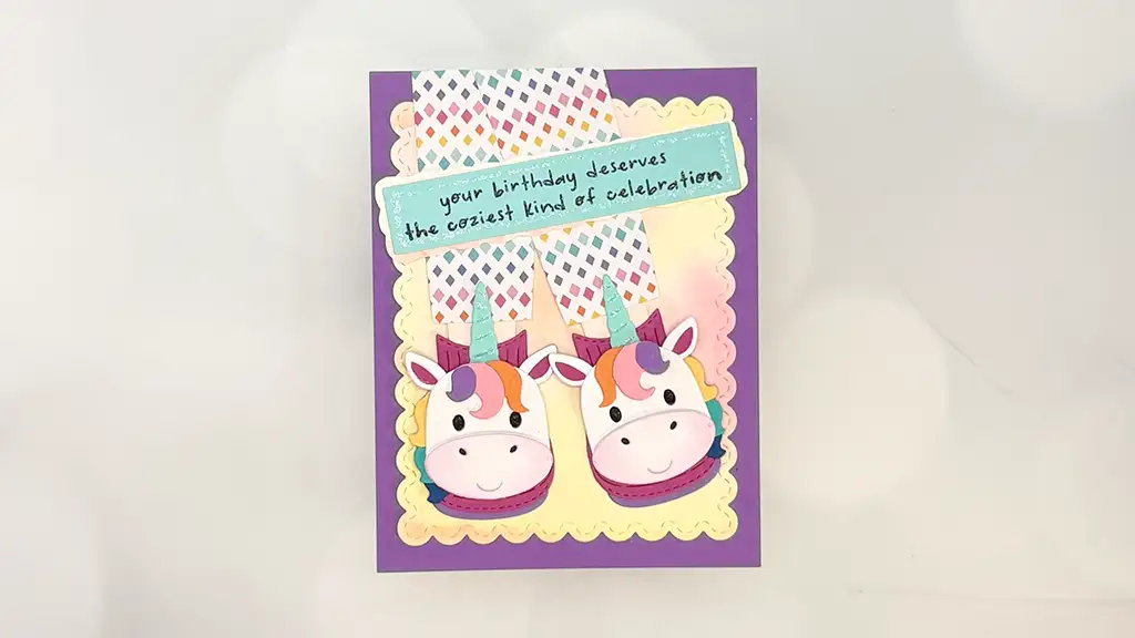 A colorful cozy birthday card featuring darling unicorn slippers and a message that reads, "your birthday deserves the coziest kind of celebration.