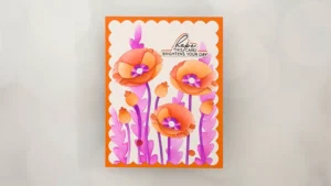 A handmade greeting card from the Jan 26 Club Kit features orange and pink flowers, purple stems, and the message "hope this card brightens your day" on a white background with an orange border—perfect for stunning cards and card making.