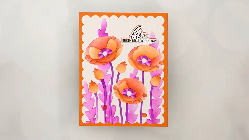 A handmade greeting card from the Jan 26 Club Kit features orange and pink flowers, purple stems, and the message "hope this card brightens your day" on a white background with an orange border—perfect for stunning cards and card making.