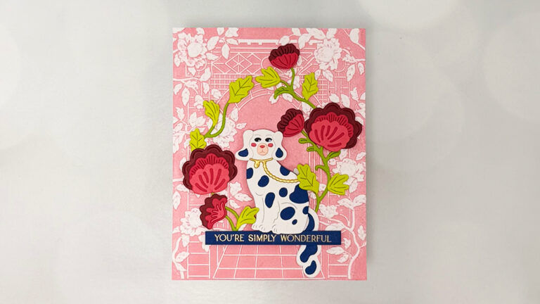 A greeting card perfect for cardmaking enthusiasts, featuring a blue-spotted white cat, red flowers, and a pink floral background. The text at the bottom reads, "YOU'RE SIMPLY WONDERFUL." From the Regal Reflections collection.